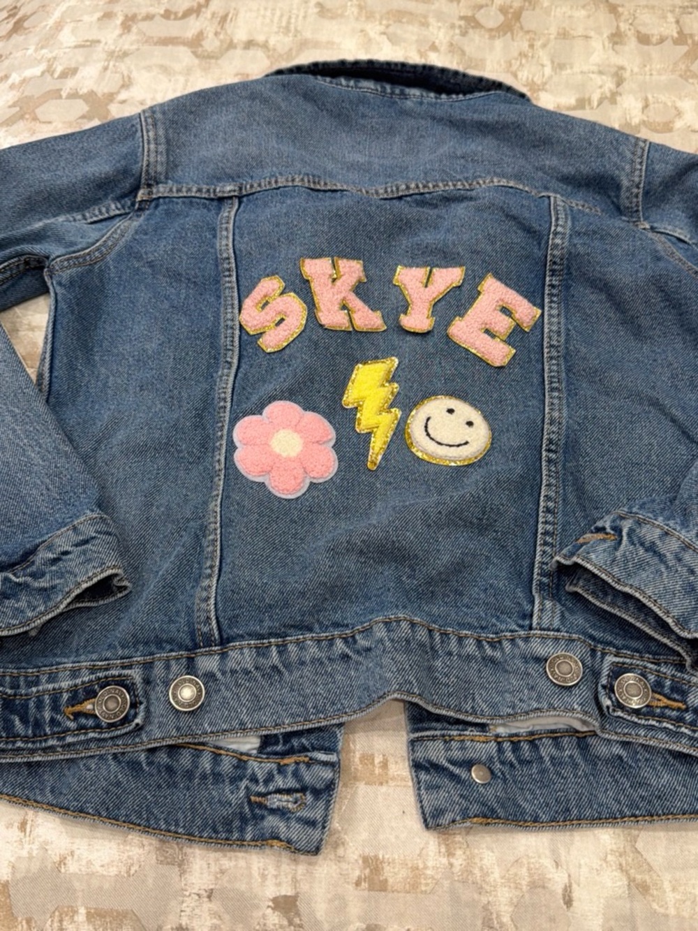Old Navy Blue Denim Jacket with Pink Letter Patches and Yellow Accents